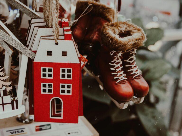 A cozy display of handmade Christmas house and skate ornaments, perfect for winter.