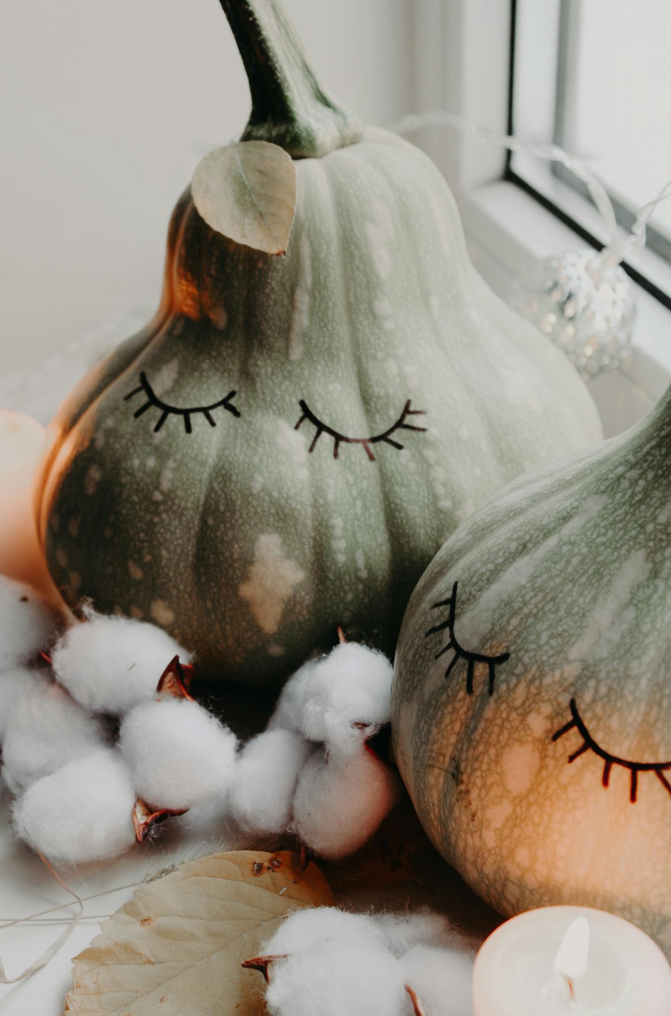 Close-up of whimsical pumpkins with cotton and cozy ambiance, perfect for autumn decor.